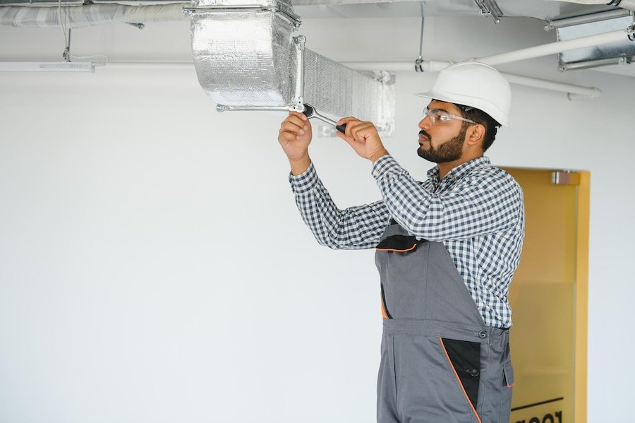 indian worker inspects ventilation system office building 255667 77130