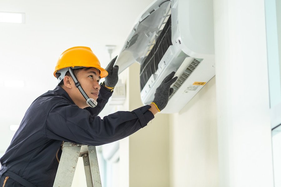 male technician repairing air conditioner safety uniform indoors 61243 422